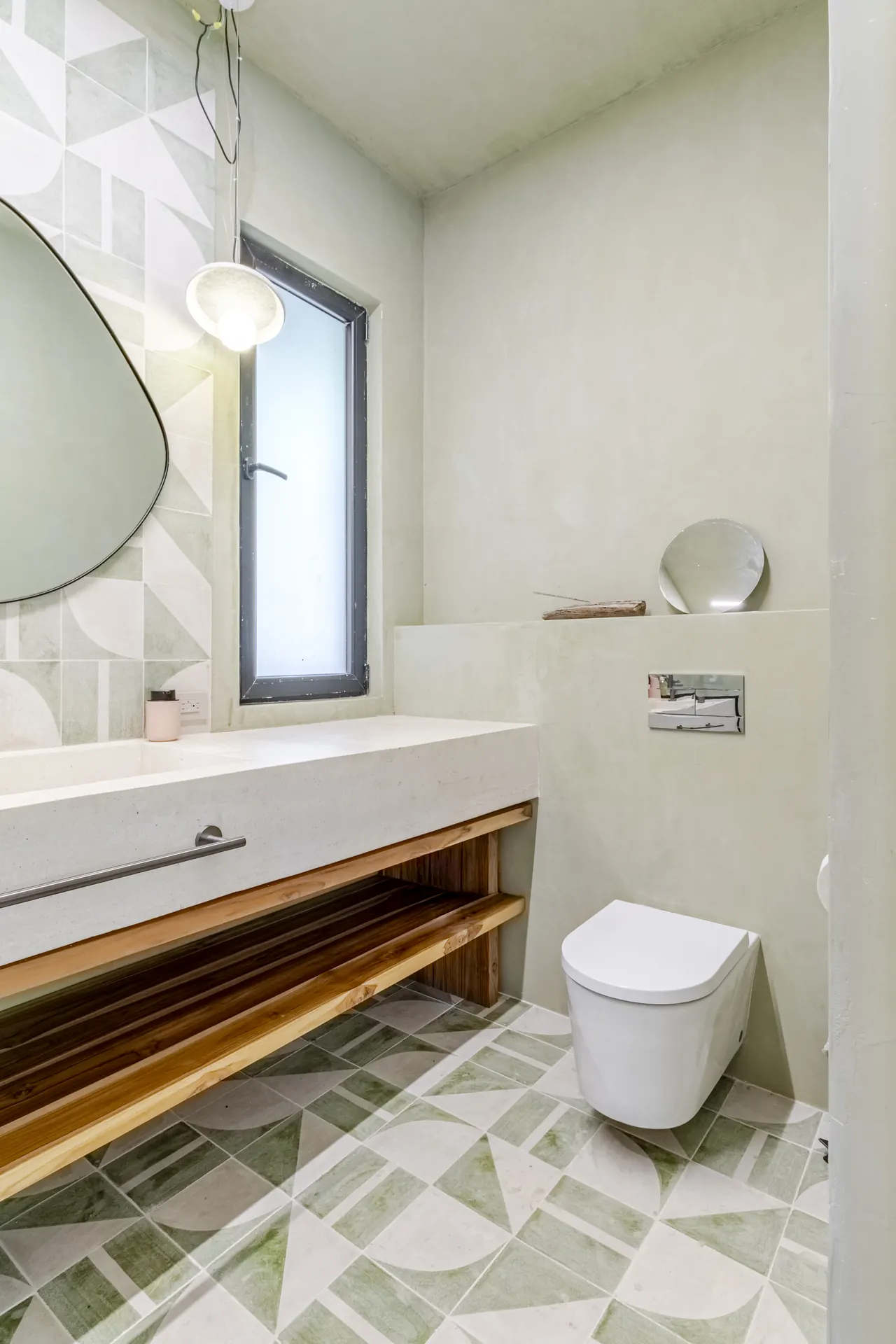Bright bathroom with a floating timber vanity and a garden-facing window