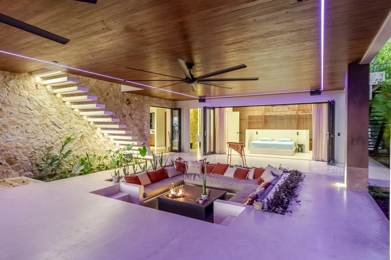 Sunken lounge and floating staircase with evening accent lighting