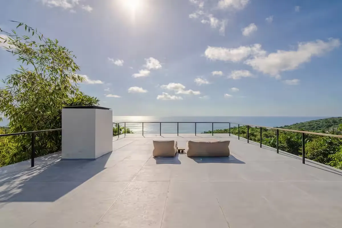 Broad upper terrace with two loungers facing the Pacific Ocean