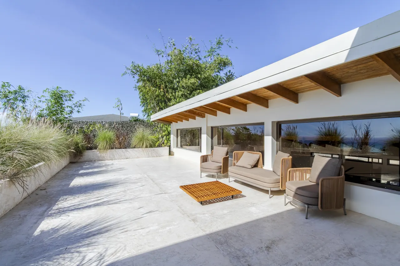 Sunny upper terrace with outdoor chairs beside the king bedroom