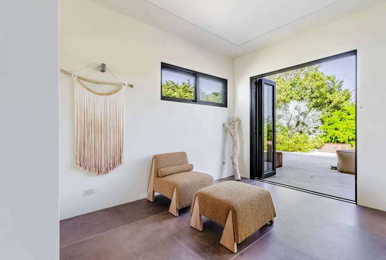 Lounge chair and footstool beside the workspace terrace doors